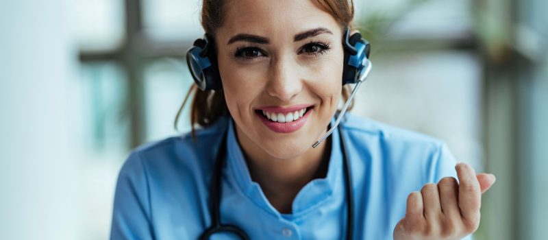 young-happy-healthcare-worker-wearing-headset-talking-with-patients-while-working-call-center (1)